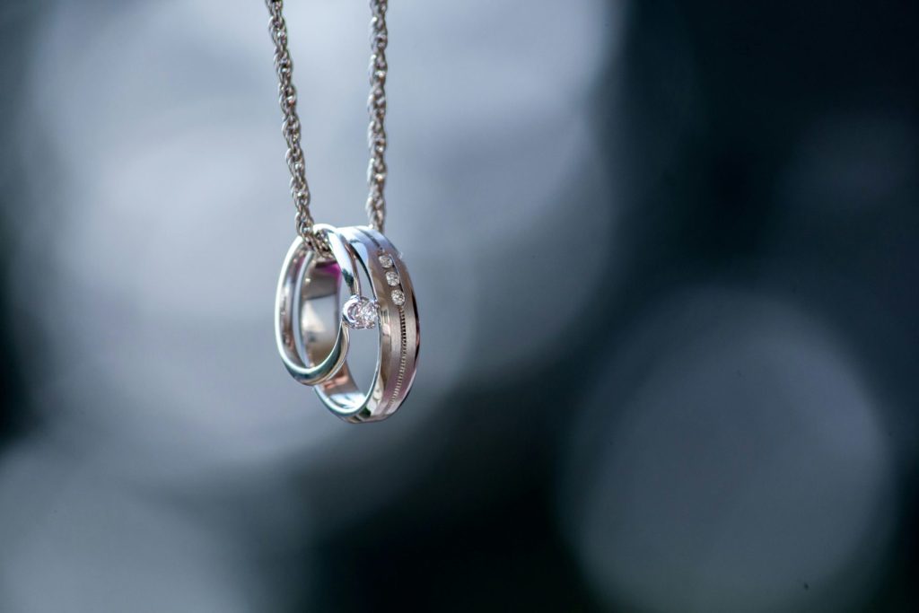 silver-colored ring pendant